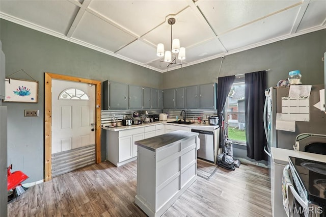 1618 N State St, Litchfield, IL 62056 - kitchen featuring stainless steel appliances, a sink, light wood-style flooring, a chandelier, and coffered ceiling