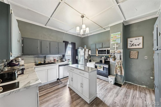 1618 N State St, Litchfield, IL 62056 - kitchen with stainless steel appliances, a sink, coffered ceiling, a chandelier, and light wood-style flooring