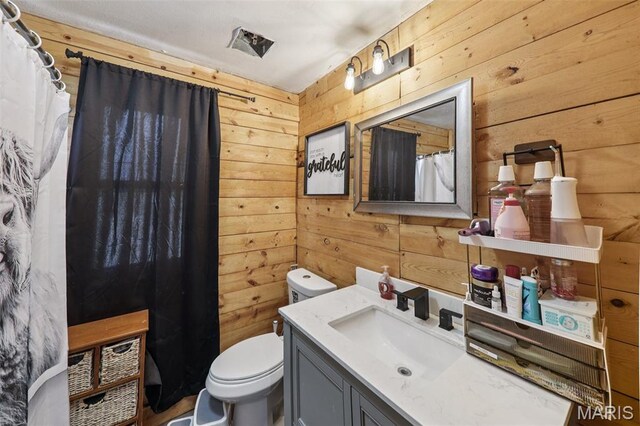 1618 N State St, Litchfield, IL 62056 - full bathroom with wood walls, vanity, toilet, and a shower with curtain