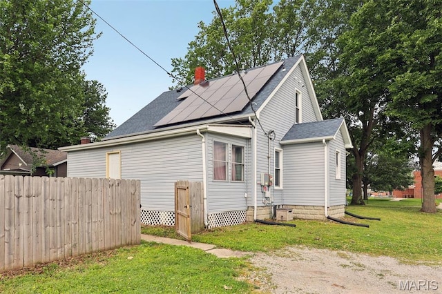 1618 N State St, Litchfield, IL 62056 - view of property exterior with roof mounted solar panels, a chimney, and a shingled roof