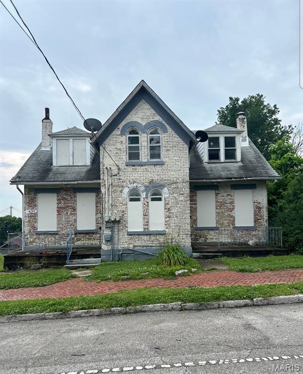 427 E 4th St, Alton, IL 62002 - view of front of house featuring a chimney and brick siding