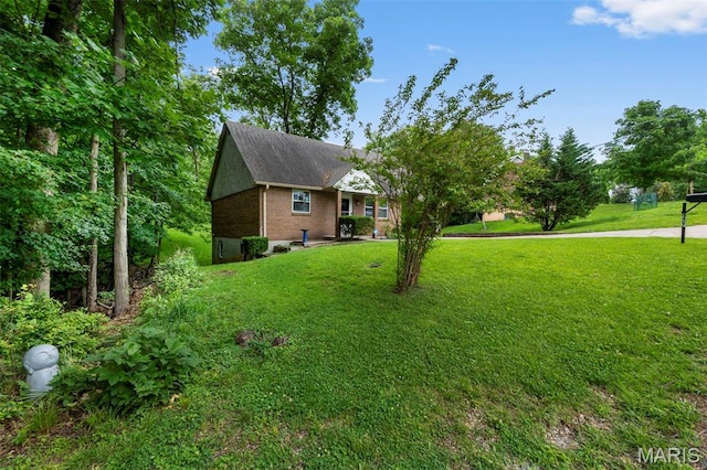 1407 Perry Ave, Cape Girardeau, MO 63701 - view of side of home featuring a yard, brick siding, and roof with shingles