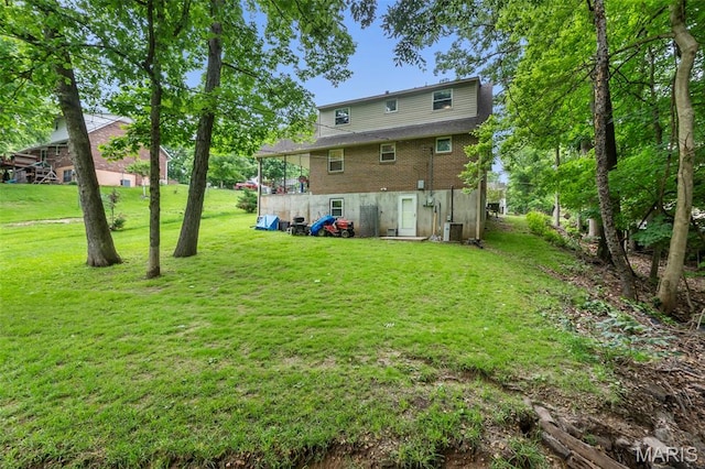 1407 Perry Ave, Cape Girardeau, MO 63701 - rear view of property with a yard, brick siding, and cooling unit