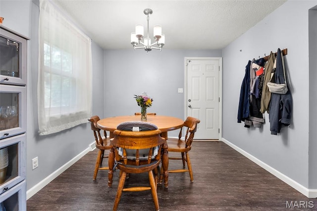 1407 Perry Ave, Cape Girardeau, MO 63701 - dining area with a chandelier, baseboards, wood finished floors, and a textured ceiling