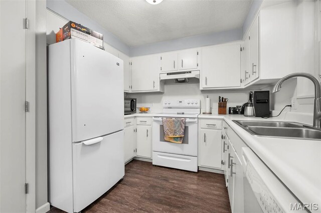 1407 Perry Ave, Cape Girardeau, MO 63701 - kitchen featuring white appliances, under cabinet range hood, a sink, dark wood-type flooring, and white cabinetry
