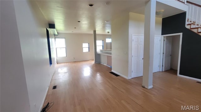 5714 Maple Ave, Saint Louis, MO 63112 - corridor featuring stairway, light wood-style flooring, and baseboards