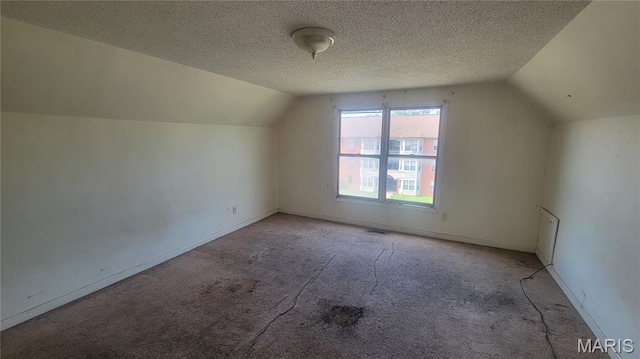 5714 Maple Ave, Saint Louis, MO 63112 - bonus room featuring lofted ceiling, light carpet, a textured ceiling, and baseboards
