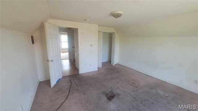 5714 Maple Ave, Saint Louis, MO 63112 - additional living space featuring lofted ceiling, baseboards, carpet floors, and a textured ceiling