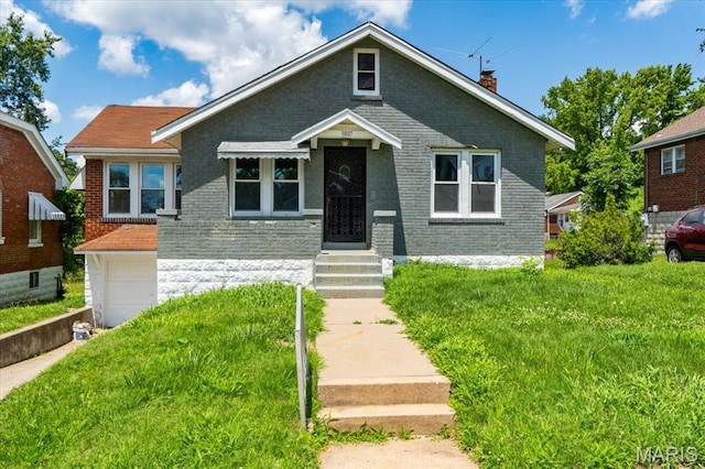 3807 Lawler Dr, Northwoods, MO 63121 - bungalow-style house with brick siding, a chimney, a front yard, and an attached garage