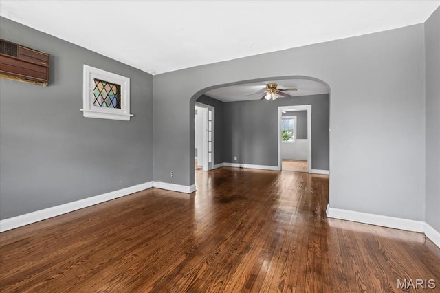 3807 Lawler Dr, Northwoods, MO 63121 - spare room with arched walkways, a ceiling fan, wood finished floors, and an AC wall unit