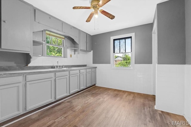 3807 Lawler Dr, Northwoods, MO 63121 - kitchen with open shelves, plenty of natural light, wood finished floors, and a ceiling fan