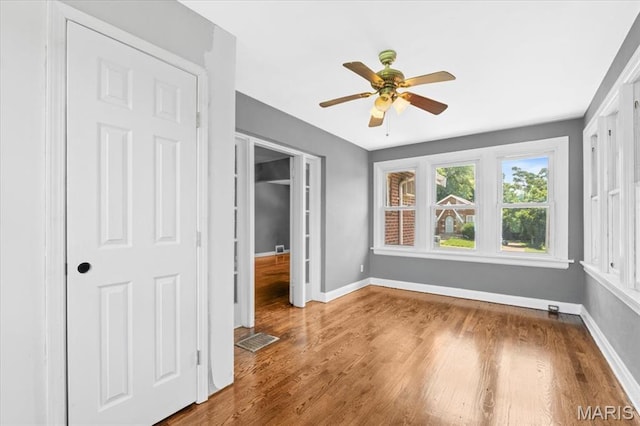 3807 Lawler Dr, Northwoods, MO 63121 - unfurnished bedroom featuring wood finished floors and a ceiling fan