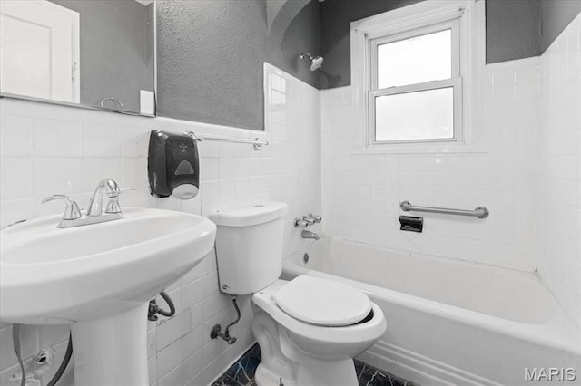 3807 Lawler Dr, Northwoods, MO 63121 - bathroom featuring tile walls,  shower combination, and a wainscoted wall