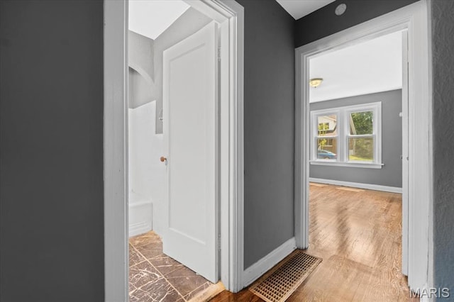 3807 Lawler Dr, Northwoods, MO 63121 - hall with baseboards and wood finished floors