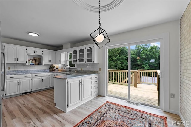 2848 S Hope St, Jackson, MO 63755 - kitchen featuring a sink, backsplash, open shelves, and white cabinets