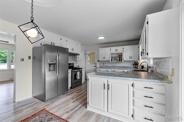 2848 S Hope St, Jackson, MO 63755 - kitchen featuring stainless steel appliances, a sink, under cabinet range hood, a peninsula, and white cabinetry