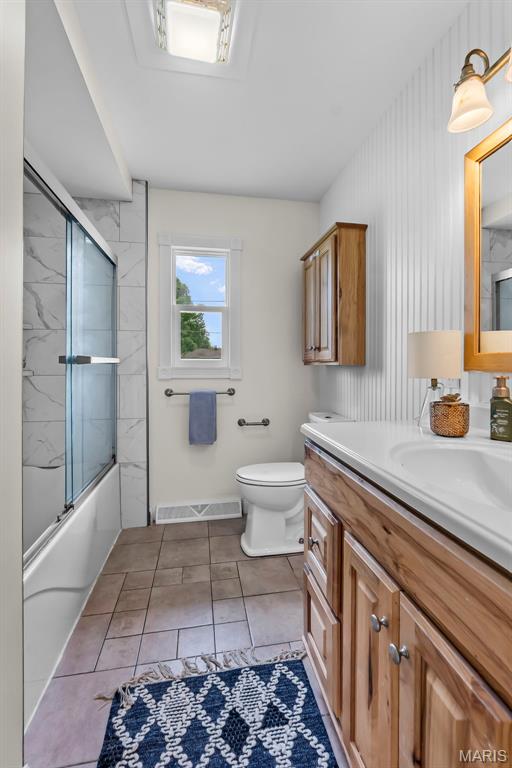 2848 S Hope St, Jackson, MO 63755 - bathroom featuring vanity, toilet, and combined bath / shower with glass door