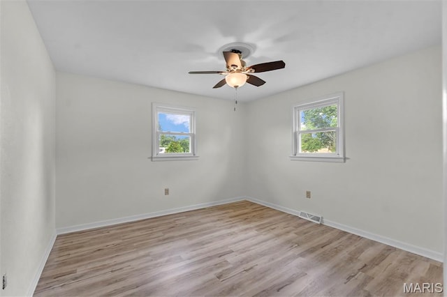 2848 S Hope St, Jackson, MO 63755 - empty room with plenty of natural light, a ceiling fan, light wood-style floors, and baseboards