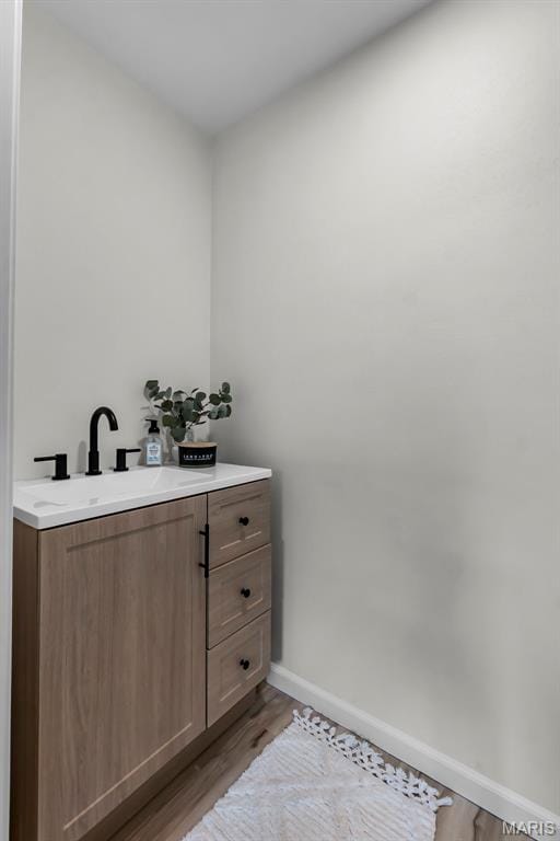 2848 S Hope St, Jackson, MO 63755 - bathroom with baseboards, vanity, and wood finished floors
