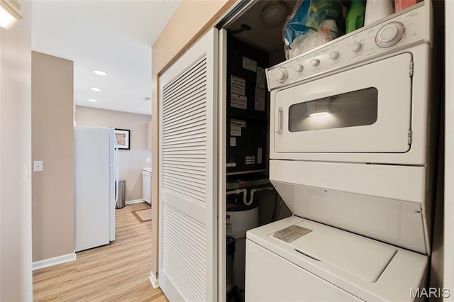 33 Monterey Dr Unit 2A, Lake Ozark, MO 65049 - laundry area with stacked washing machine and dryer, light wood-type flooring, baseboards, and recessed lighting