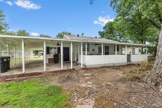 500 Frisco Rd, Campbell, MO 63933 - back of house featuring a ceiling fan, a sunroom, an attached carport, and metal roof