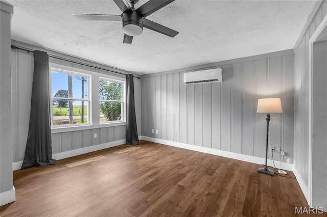 500 Frisco Rd, Campbell, MO 63933 - empty room with a wall mounted AC, a textured ceiling, wood finished floors, baseboards, and ceiling fan