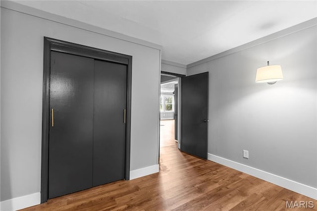 500 Frisco Rd, Campbell, MO 63933 - unfurnished bedroom featuring baseboards, wood finished floors, and a closet