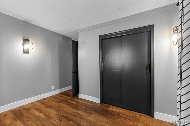 500 Frisco Rd, Campbell, MO 63933 - unfurnished bedroom with baseboards, wood finished floors, and a closet