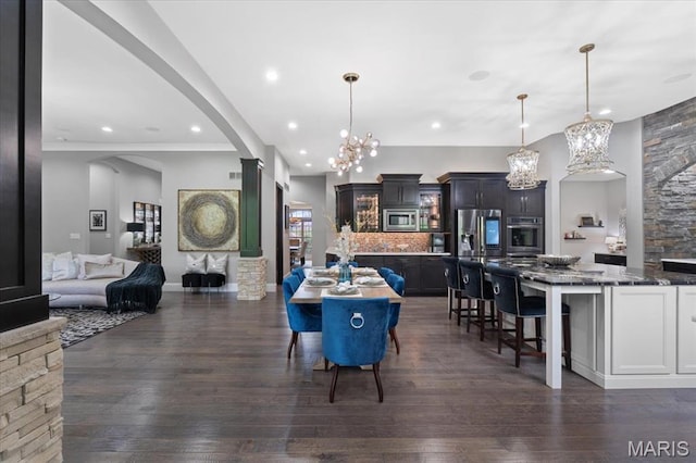 5 Watch Hill Rd, Ladue, MO 63124 - dining space featuring a chandelier, dark wood finished floors, arched walkways, and recessed lighting