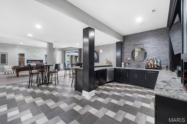 5 Watch Hill Rd, Ladue, MO 63124 - kitchen featuring dark cabinetry, open floor plan, recessed lighting, a tiled fireplace, and dishwasher