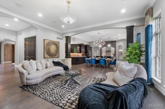 5 Watch Hill Rd, Ladue, MO 63124 - living room featuring arched walkways, a chandelier, dark wood finished floors, decorative columns, and recessed lighting