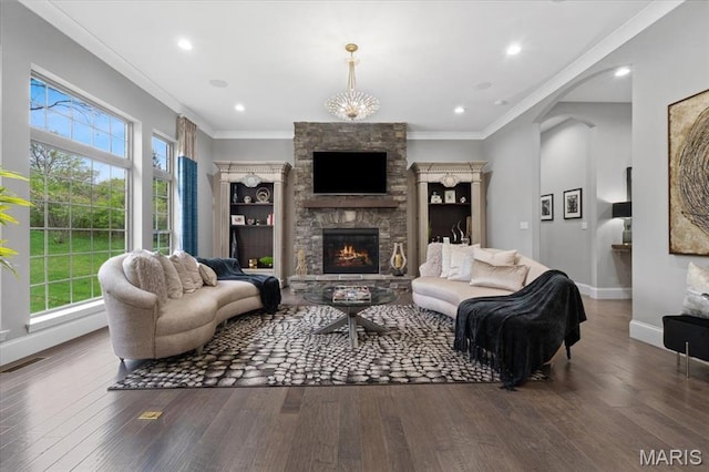 5 Watch Hill Rd, Ladue, MO 63124 - living room with healthy amount of natural light, a stone fireplace, wood finished floors, and crown molding