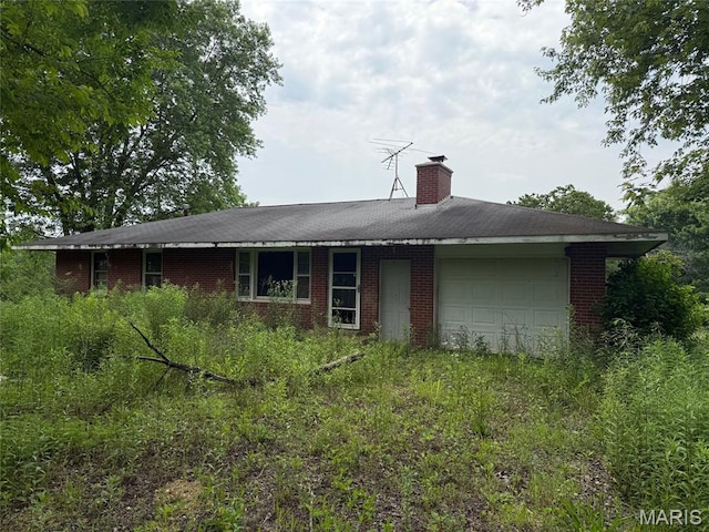 26074 Bcr 306, Marble Hill, MO 63764 - back of house with a garage, brick siding, and a chimney