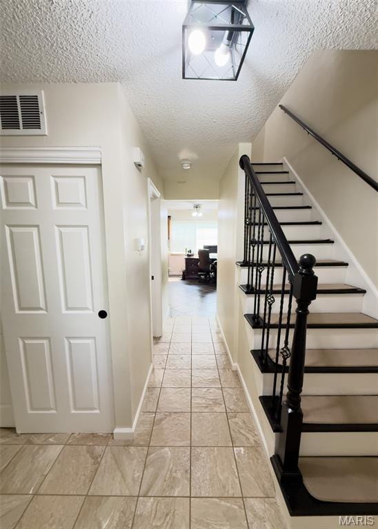 11630 Carolview Dr, Florissant, MO 63033 - corridor featuring baseboards, stairs, and a textured ceiling