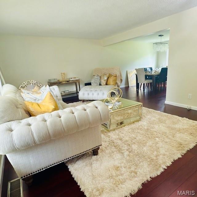 11630 Carolview Dr, Florissant, MO 63033 - living area featuring baseboards, wood finished floors, and a chandelier