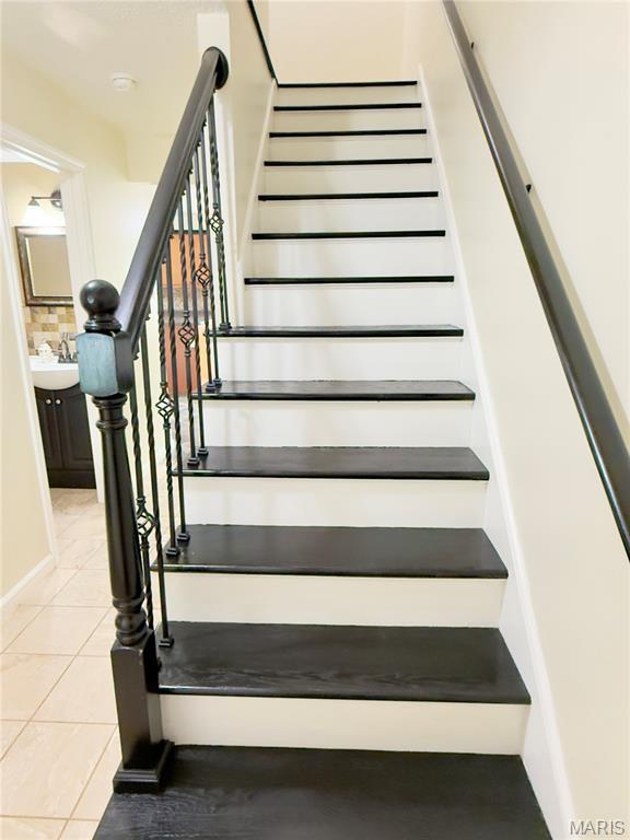 11630 Carolview Dr, Florissant, MO 63033 - staircase featuring tile patterned floors