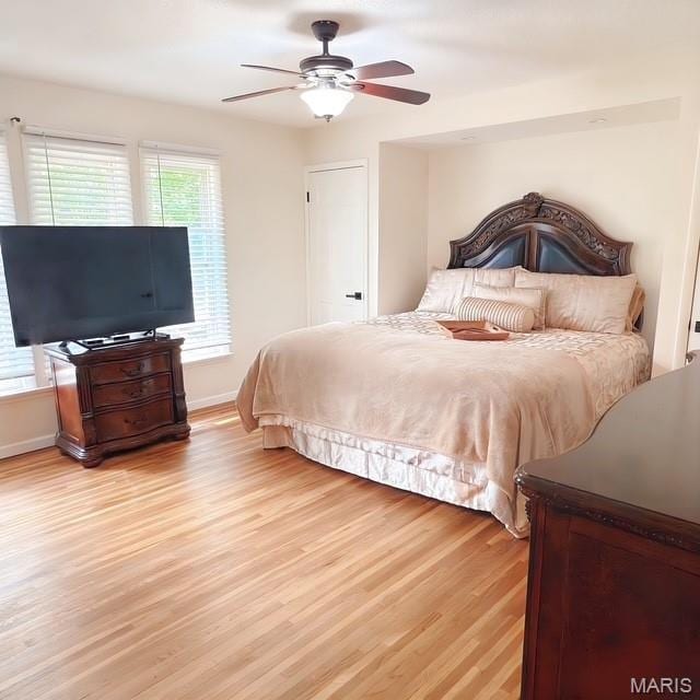 11630 Carolview Dr, Florissant, MO 63033 - bedroom with light wood finished floors, baseboards, and a ceiling fan