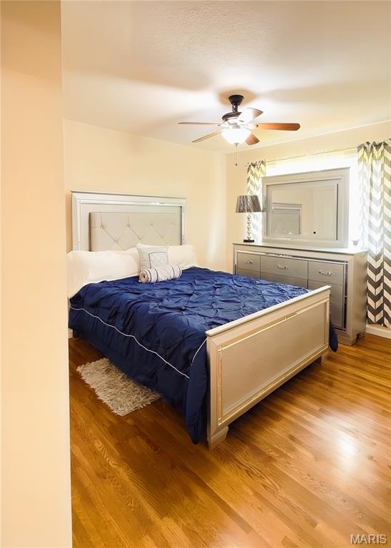 11630 Carolview Dr, Florissant, MO 63033 - bedroom featuring light wood-style floors and a ceiling fan