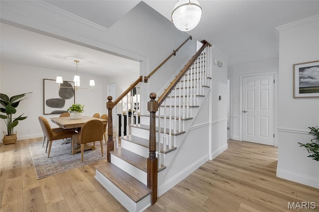 173 Portico Dr, Chesterfield, MO 63017 - stairway with wood finished floors, ornamental molding, baseboards, and a chandelier
