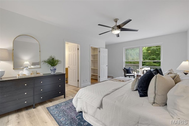 173 Portico Dr, Chesterfield, MO 63017 - bedroom featuring light wood-type flooring, ceiling fan, and a spacious closet