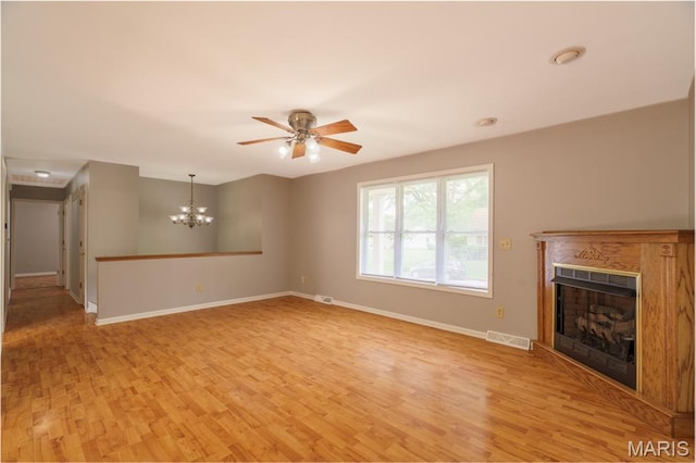 1804 Meadow Ct, Rolla, MO 65401 - unfurnished living room featuring light wood-style flooring, a fireplace, baseboards, ceiling fan, and a chandelier