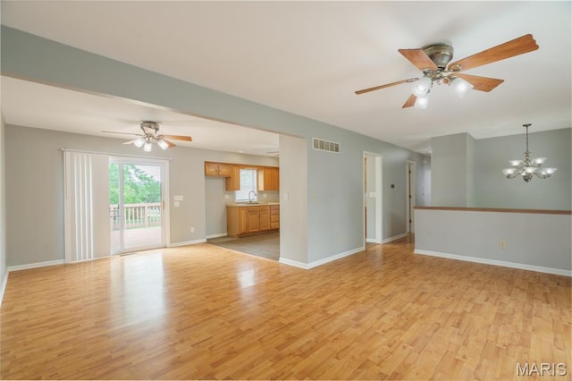 1804 Meadow Ct, Rolla, MO 65401 - unfurnished living room with a sink, light wood-style floors, a chandelier, and a ceiling fan
