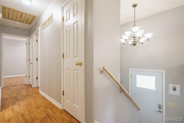 1804 Meadow Ct, Rolla, MO 65401 - corridor featuring light wood finished floors, a chandelier, an upstairs landing, and baseboards