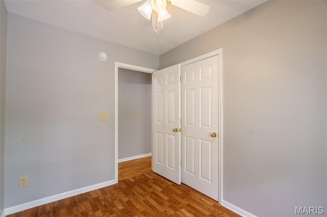 1804 Meadow Ct, Rolla, MO 65401 - unfurnished bedroom featuring baseboards, wood finished floors, a closet, and ceiling fan