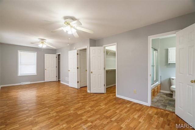 1804 Meadow Ct, Rolla, MO 65401 - unfurnished bedroom featuring light wood-type flooring, baseboards, ensuite bath, and a spacious closet