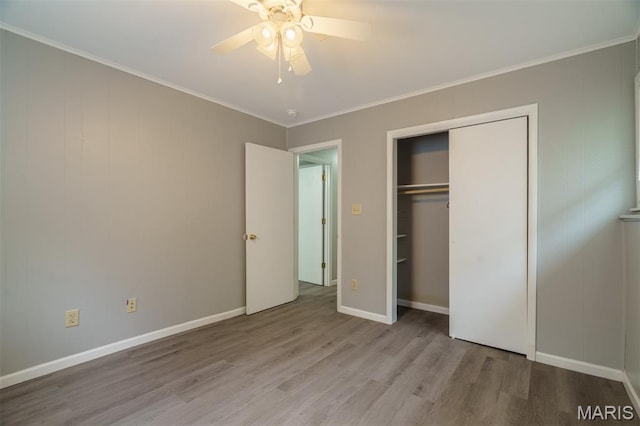 1804 Meadow Ct, Rolla, MO 65401 - unfurnished bedroom with wood finished floors, a closet, a ceiling fan, ornamental molding, and baseboards