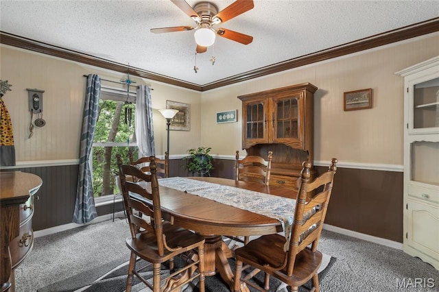 116 Shirewood Dr, Saint Charles, MO 63303 - dining room featuring crown molding, carpet flooring, ceiling fan, a textured ceiling, and wood walls