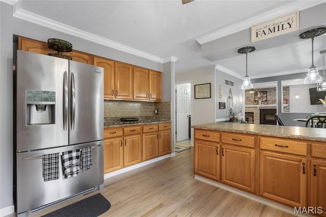 116 Shirewood Dr, Saint Charles, MO 63303 - kitchen with stainless steel fridge, light wood-type flooring, ornamental molding, backsplash, and brown cabinetry