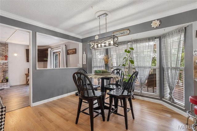 116 Shirewood Dr, Saint Charles, MO 63303 - dining room featuring a chandelier, crown molding, wood finished floors, and a textured ceiling