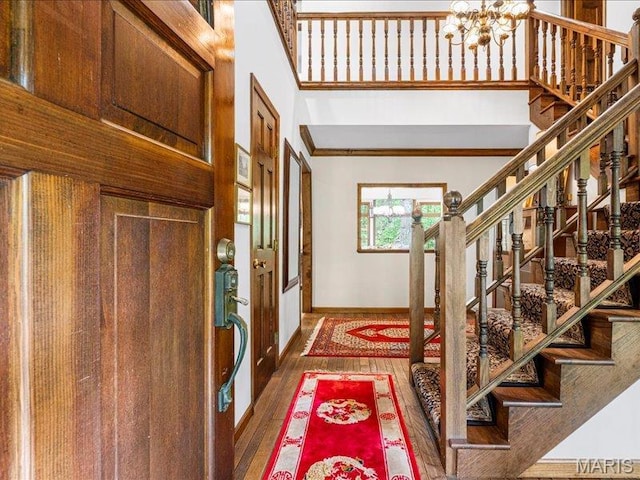 2254 Ridgley Woods Dr, Chesterfield, MO 63005 - foyer entrance with stairs, a chandelier, baseboards, wood finished floors, and a towering ceiling